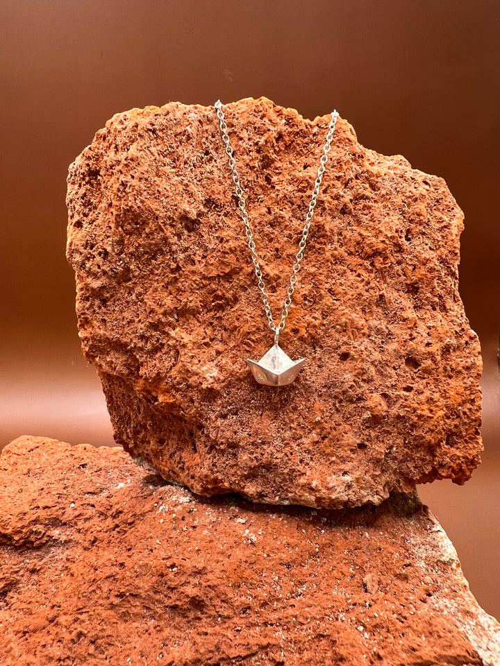 Paper Memory – Origami Boat Necklace A small silver boat, carrying memories across the quiet sea of the heart.