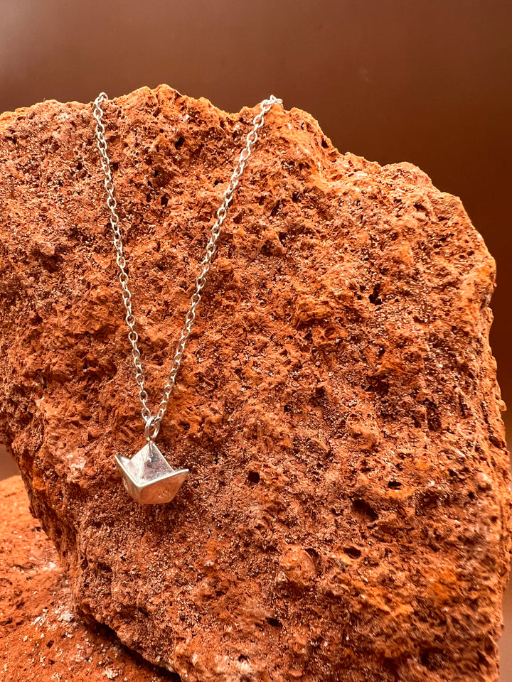 Paper Memory – Origami Boat Necklace A small silver boat, carrying memories across the quiet sea of the heart.