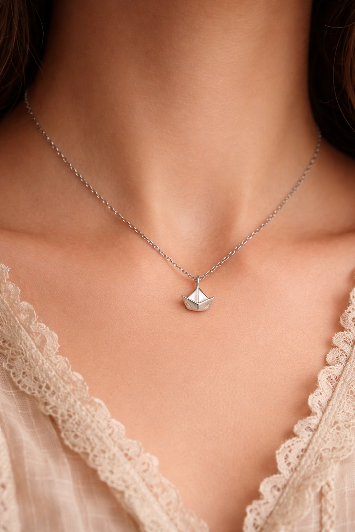 Paper Memory – Origami Boat Necklace A small silver boat, carrying memories across the quiet sea of the heart.