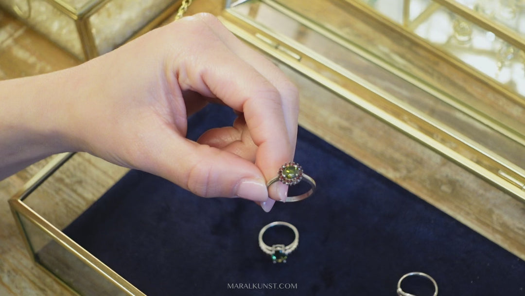 a garnet gemstone ring in sterling silver is laying on a stone