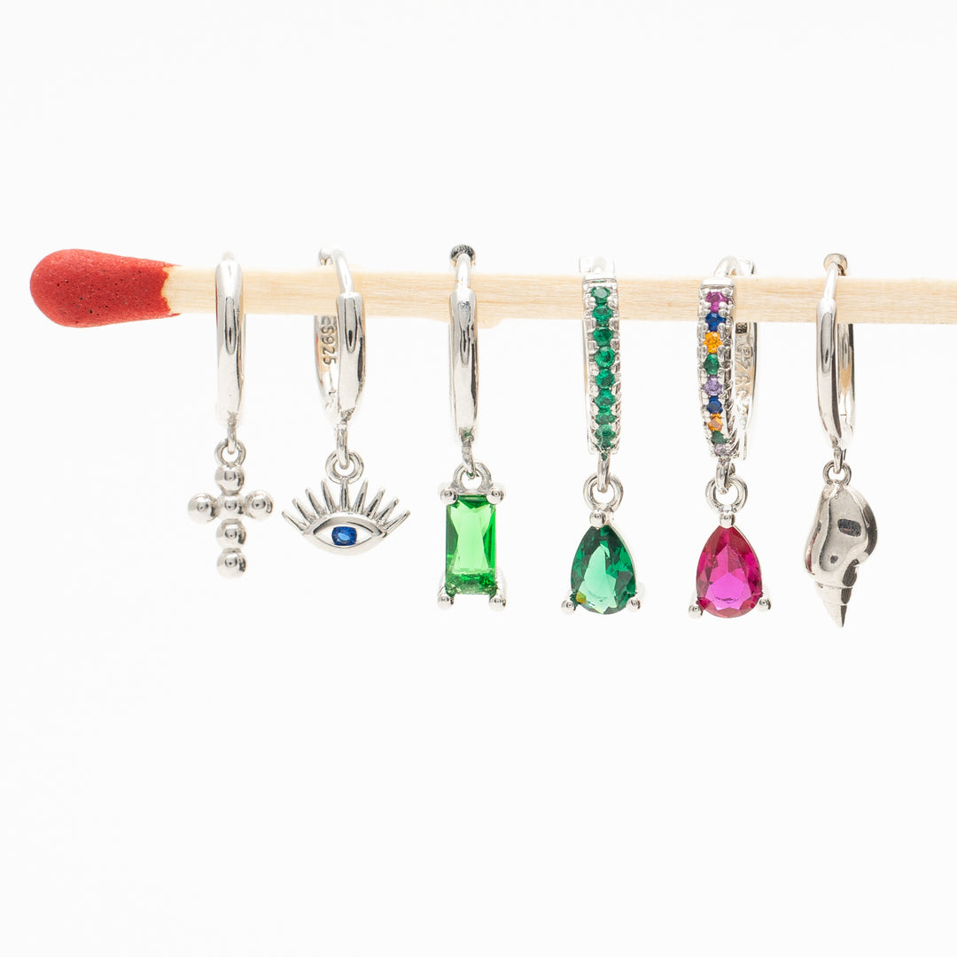 red stone earrings in sterling silver are hanging on a stick