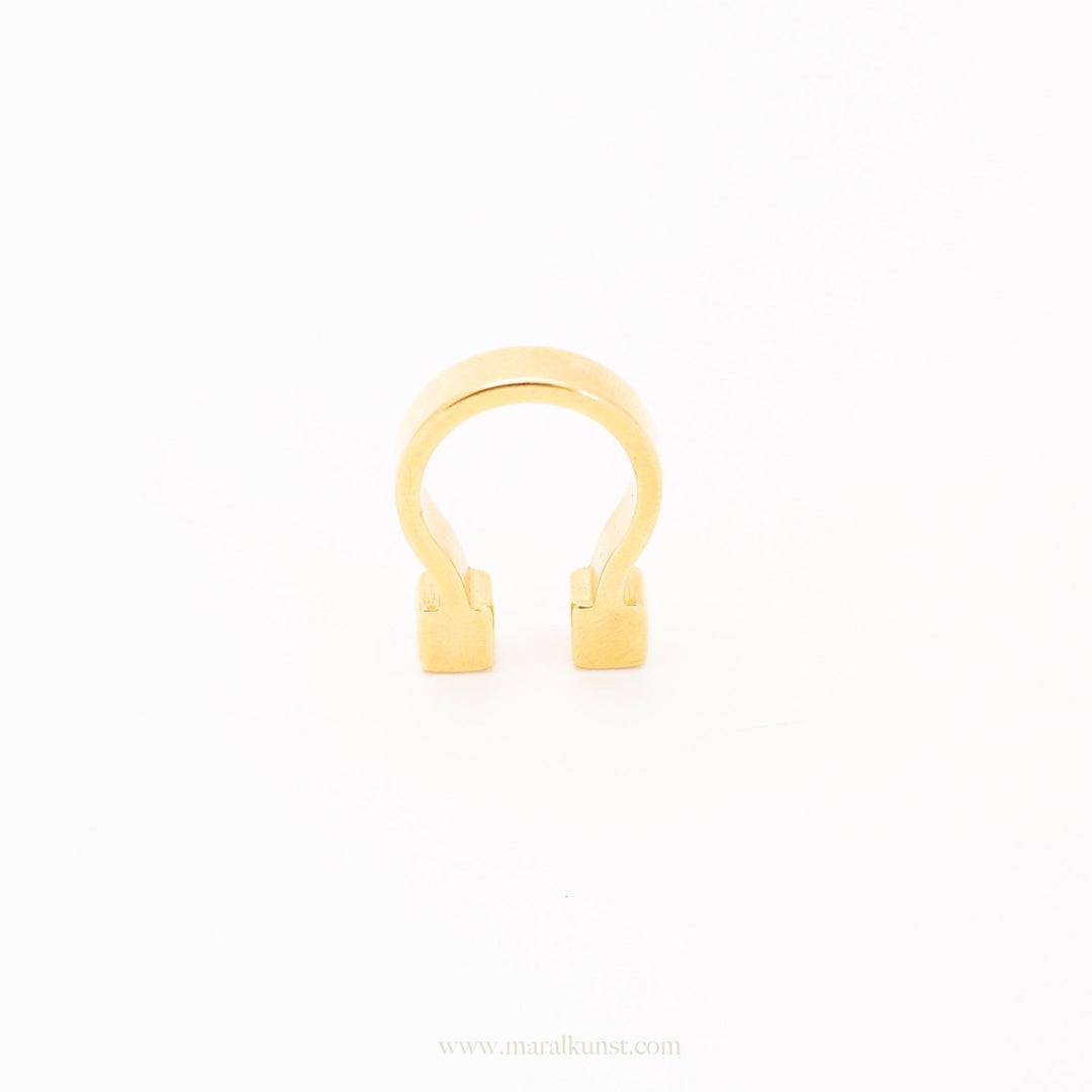 a women wears a ring in gold plated steel