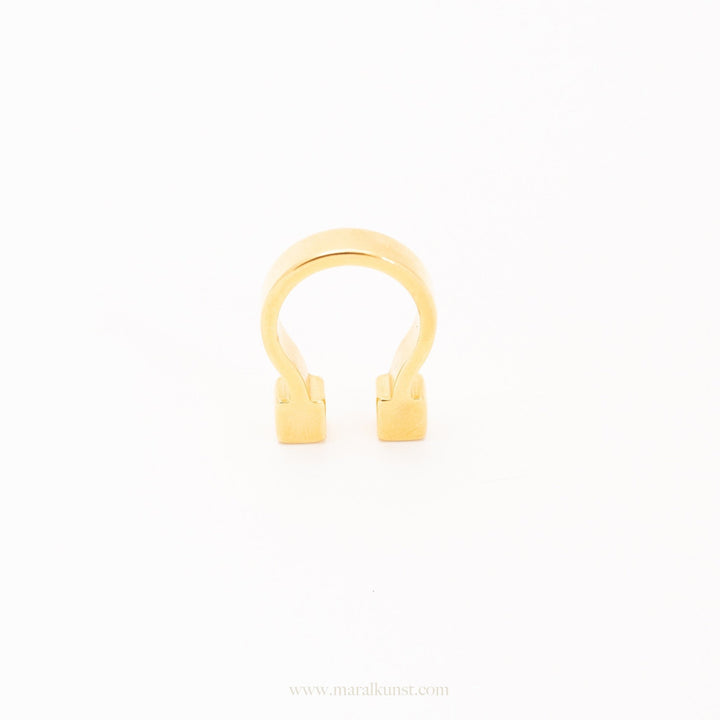a women wears a ring in gold plated steel