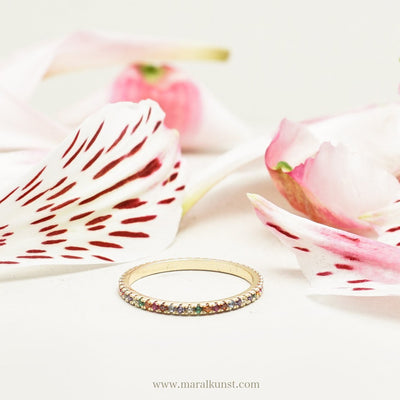 a ring in stainless steel is surrounded with flower petals