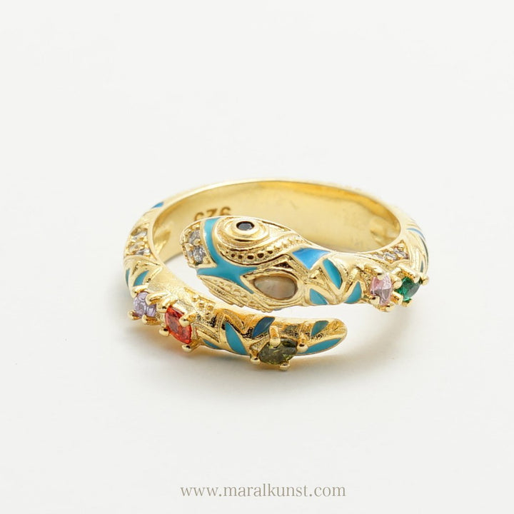 a snake shape ring in 925 sterling silver is putting on the table